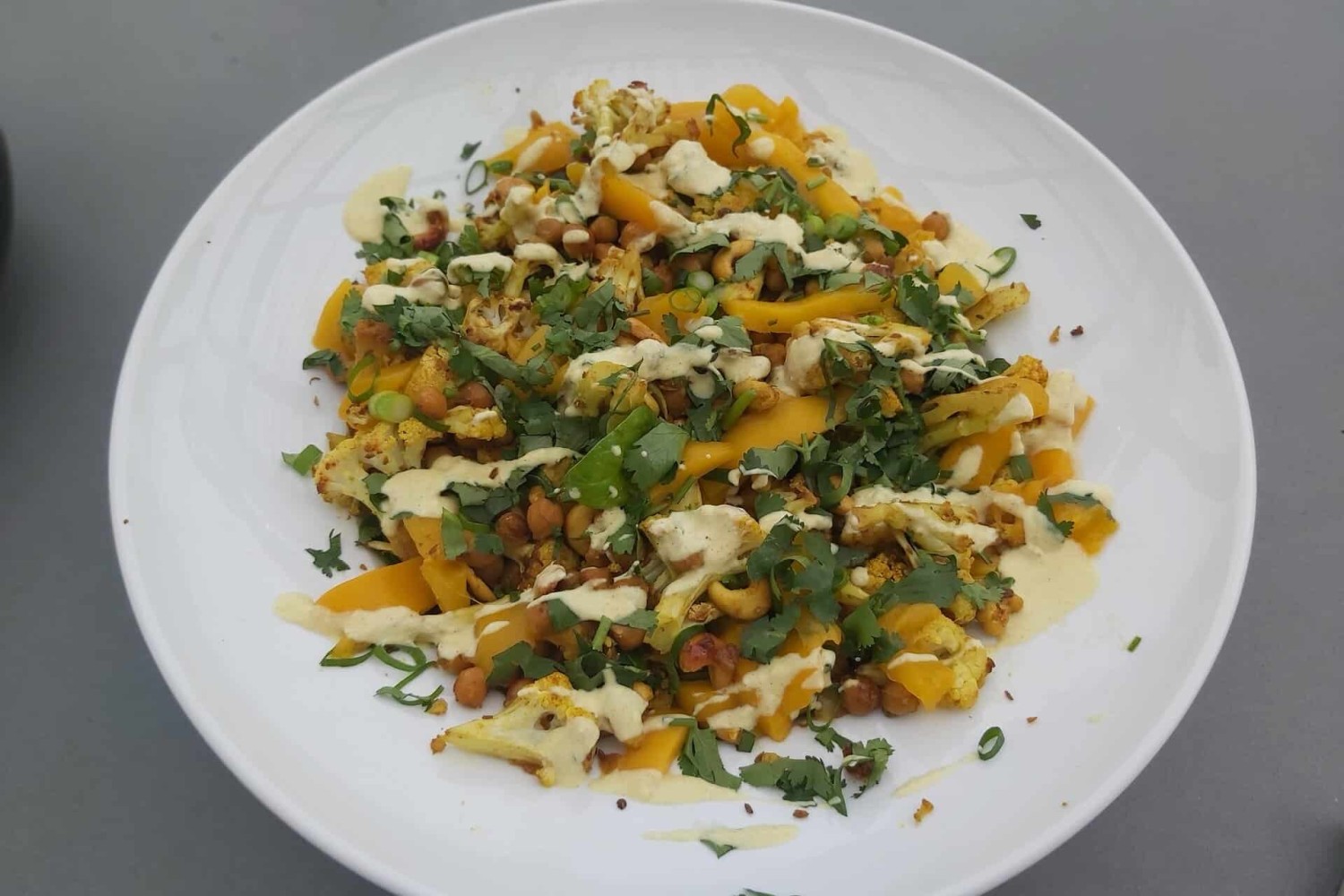 A simple, feel-good salad with spiced cauliflower, chickpeas, fresh greens and a creamy yoghurt dressing — perfect for dinner or work lunches.