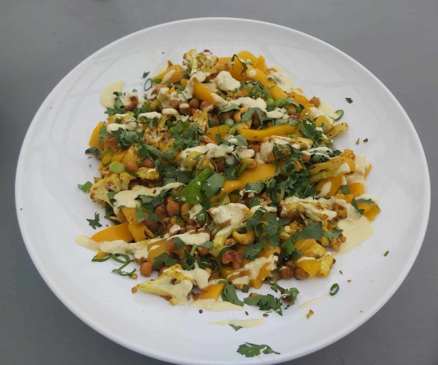 A simple, feel-good salad with spiced cauliflower, chickpeas, fresh greens and a creamy yoghurt dressing — perfect for dinner or work lunches.